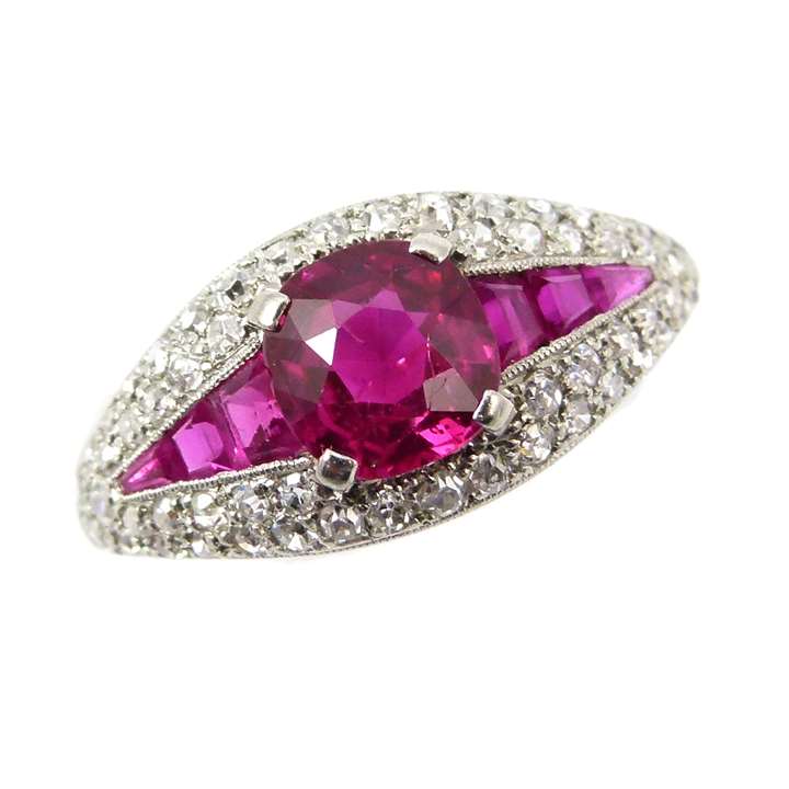 Ruby and diamond boat shaped cluster ring, the central cushion cut Burma ruby of approximately 1.30ct.